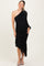 woman wearing a black one-shoulder maternity dress with ruching and a ruffled hemline