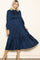 woman wearing a navy blue long sleeve smocked midi dress with a tiered skirt and puff sleeves