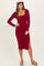 woman wearing a burgundy long sleeve ribbed midi dress with a side slit and a flat cap