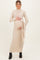 woman wearing a beige ribbed maternity maxi dress with a tie waist, showcasing her baby bump