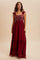 woman wearing a burgundy maxi dress with sequined bodice and ruffled straps