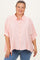 woman wearing a pink and white striped maternity plus button-up shirt with rolled sleeves and a relaxed fit