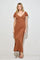 woman wearing a rust-colored maxi dress with short sleeves and a deep v-neckline