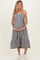 woman wearing a black and white gingham maternity dress with a tiered skirt and holding her baby bump
