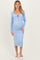 woman wearing a light blue ribbed maternity dress with a tie detail and a visible baby bump