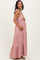 woman wearing a dusty pink striped maternity maxi dress and holding her baby bump