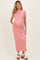 woman wearing a light pink ribbed maternity dress with short sleeves and a visible baby bump