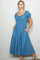 woman wearing a light blue denim midi dress with puff sleeves and pockets