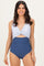 woman wearing a navy blue and white striped one-piece swimsuit with a knotted front and high-waisted bottom