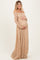 woman wearing a nude off-the-shoulder lace maternity gown and holding her baby bump