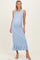 woman wearing a light blue ribbed maternity maxi dress with a ruffled hem and a visible baby bump
