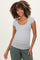 woman wearing a gray short sleeve maternity top with a scoop neckline and a fitted style, smiling