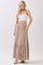 woman wearing a white strapless top and a beige maxi skirt with buttons and a smocked waist