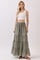 woman wearing a white cropped tank top and long olive green tiered maxi skirt