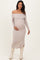 woman wearing a light taupe off-shoulder maternity dress with long sleeves and a visible baby bump