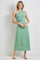 woman wearing a green one-shoulder maxi dress with a fitted bodice and flowing skirt