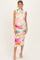 woman wearing a floral print maternity dress with a fitted silhouette and a visible baby bump