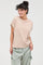 woman wearing a taupe oversized t-shirt with rolled sleeves and light green joggers