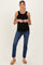 woman wearing a black ribbed maternity tank top and blue jeans, showing her baby bump
