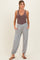 woman wearing a brown ribbed maternity tank top and gray maternity pants with pockets and drawstring cuffs