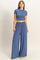 woman wearing a blue cropped t-shirt and matching wide-leg pants
