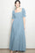 woman wearing a light blue square neck maxi dress with puff sleeves and tiered hem
