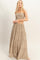 woman wearing a strapless beige tiered maxi dress with a smocked bodice and flowing skirt