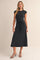 woman wearing a black cap sleeve midi dress with a waist tie and floral pattern