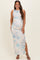 woman wearing a floral print maternity maxi dress with side slit and accentuating her baby bump