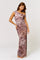 woman wearing a one-shoulder long floral maxi dress with a side slit and a fitted silhouette
