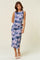 woman wearing a sleeveless purple and blue tie-dye midi dress with a form-fitting silhouette and side ruching