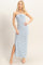 woman wearing a blue and white striped strapless maxi dress with a tie front and side slit