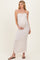 woman wearing a light pink striped maternity maxi dress with a strapless design and a baby bump visible