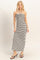 woman wearing a black and white striped halter maxi dress with a front twist detail and side slits