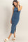 woman wearing a blue sleeveless midi dress with side slits and a fitted silhouette