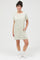 woman wearing a light green striped short sleeve dress with pockets and styled with white ankle socks