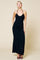 woman wearing a black sleeveless maxi dress with a fitted silhouette and adjustable spaghetti straps