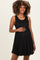 woman wearing a black ribbed maternity dress and holding her baby bump