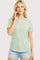 woman wearing a green and white striped short sleeve t-shirt with a relaxed fit and distressed denim shorts