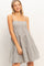 woman wearing a striped tiered sundress with spaghetti straps and a relaxed fit