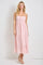 woman wearing a pink floral maxi dress with spaghetti straps and a tiered skirt