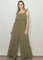 woman wearing an olive green ruffled jumpsuit with wide legs and adjustable straps