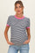 woman wearing a black and white striped maternity top with pink trim and a visible baby bump