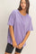 woman wearing a loose-fitting lavender oversized t-shirt paired with black bike shorts