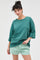 woman wearing an oversized green t-shirt and light green striped shorts