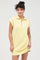 woman wearing a light yellow zip-up short sleeve dress with a relaxed fit and a casual style