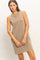 woman wearing a tan sleeveless casual dress with a relaxed fit
