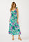 woman wearing a vibrant floral maxi dress with a deep v-neck and ruffled straps