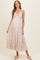 woman wearing a floral print maternity maxi dress with a v-neckline and a baby bump visible