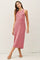 woman wearing a pink ribbed sleeveless midi dress with a relaxed fit and side slits